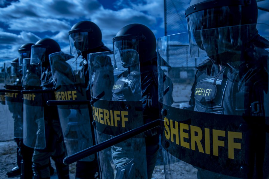 10HG1. The Evolution, Design, and Uses of Riot Shields. Police lined up to protect. Riot